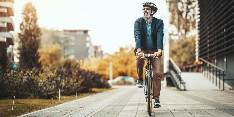An older man rides his bike in the city