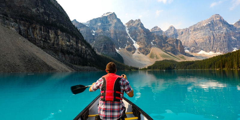 man canoeing in alberta visitors to canada insurance